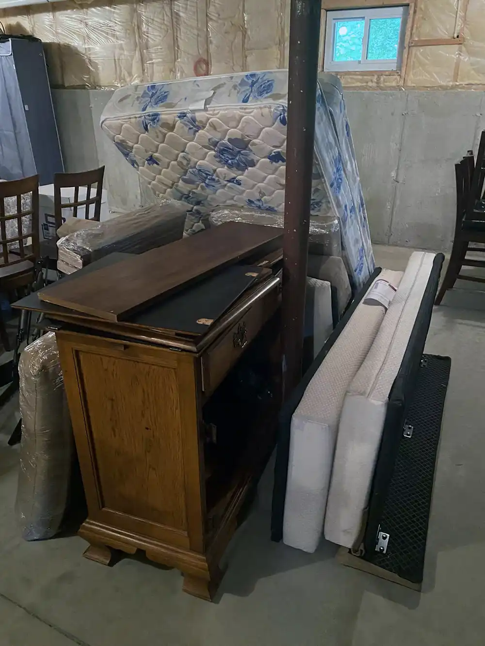Old mattress and furniture placed in a client's attic.